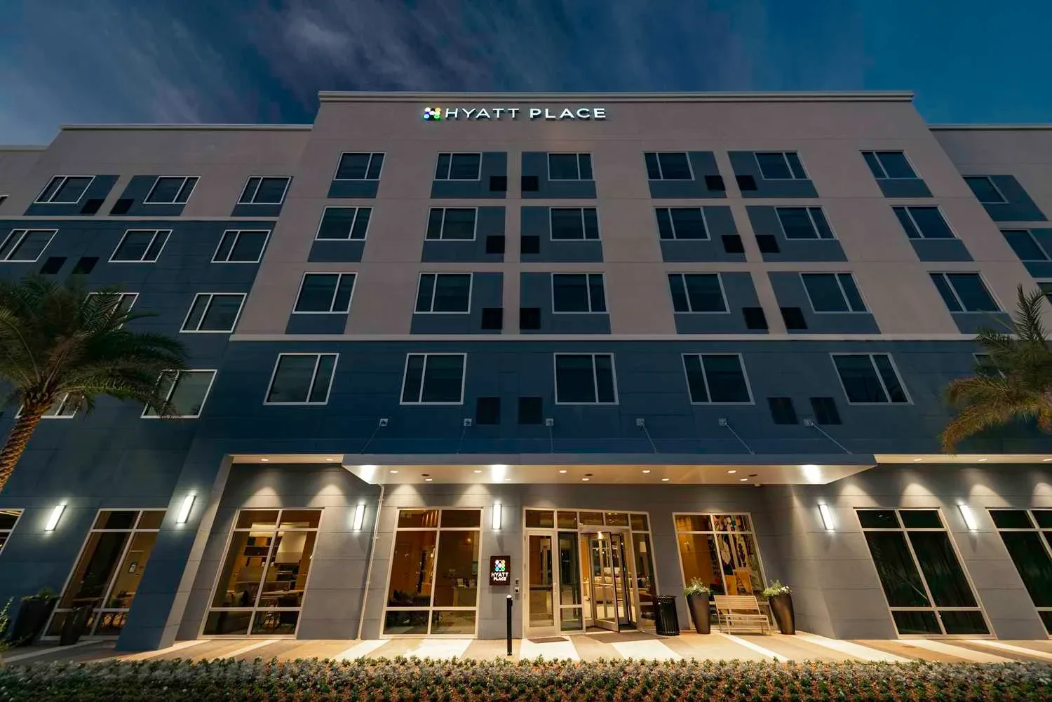 Hyatt Place Sandestin at Grand Boulevard exterior and entrance at dusk.