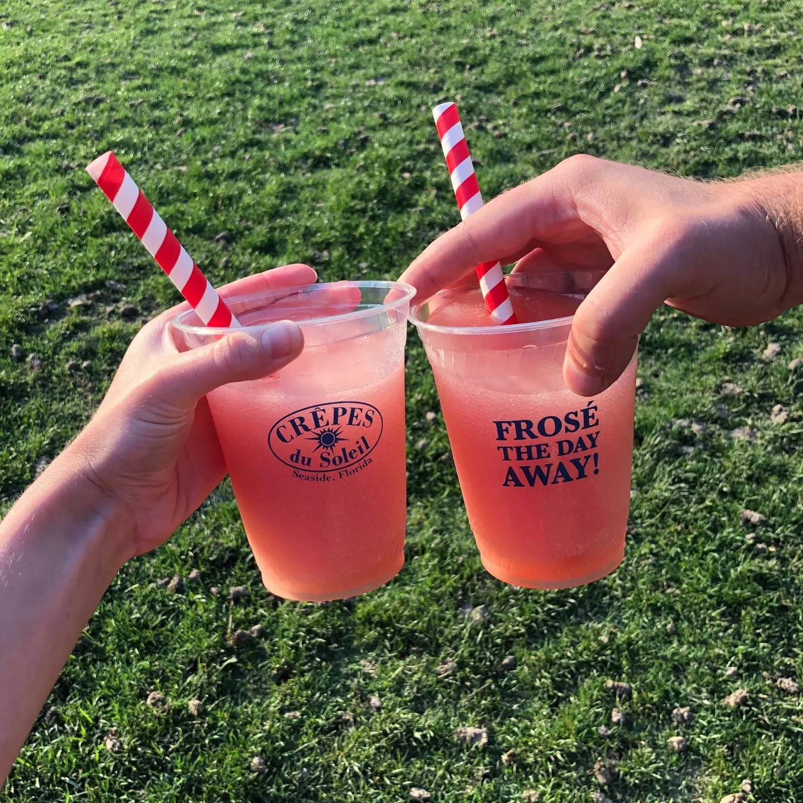 Two frozen rosé drinks in branded Crêpes du Soleil cups.