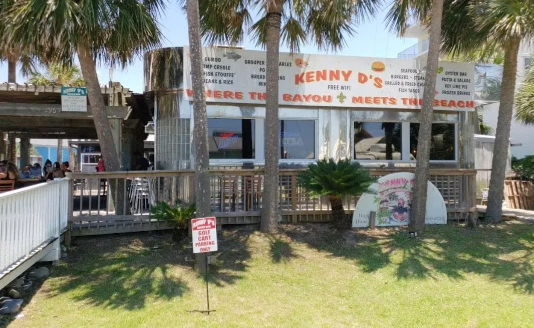 Kenny D’s restaurant exterior and patio on Scenic Gulf Drive in Miramar Beach.