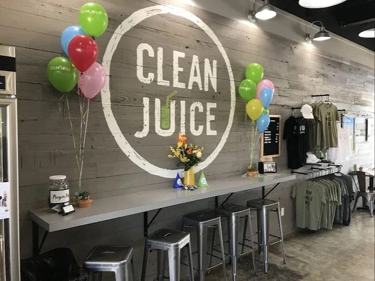 Interior seating and Clean Juice wall logo at The Market Shops