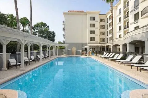 Outdoor pool and hotel building at Courtyard Sandestin at Grand Boulevard